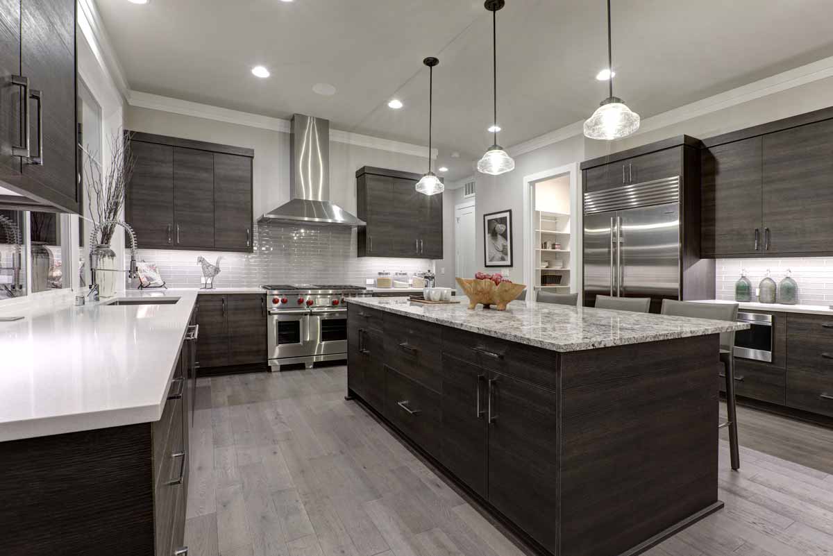 Kitchen with dark wood cabinets, granite countertops, and stainless steel appliances